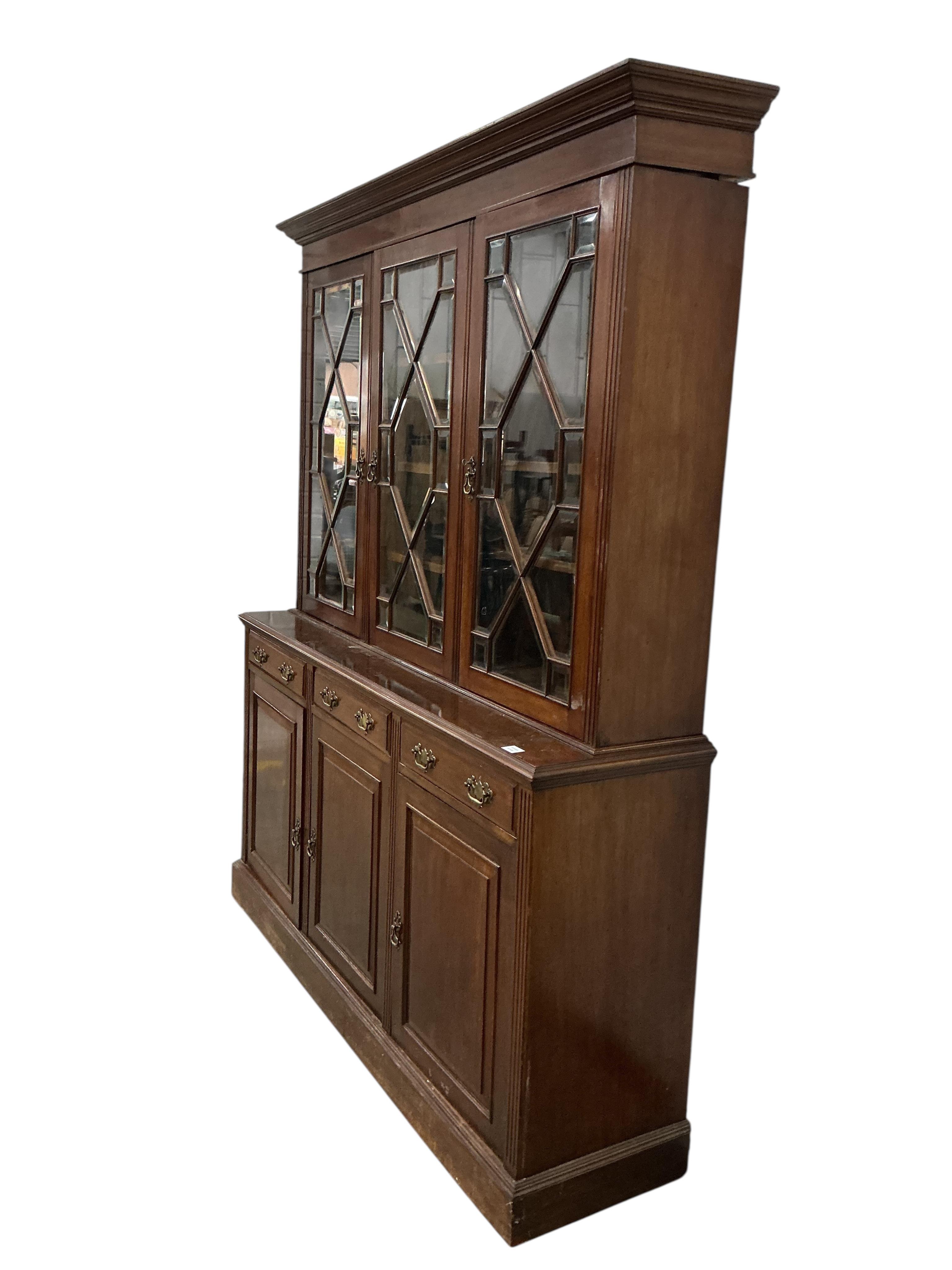 A late Victorian mahogany library bookcase with glazed upper section, width 184cm, depth 46cm, height 222cm